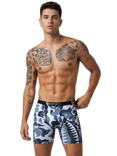 Man wearing blue and white patterned underwear with branding on a white background